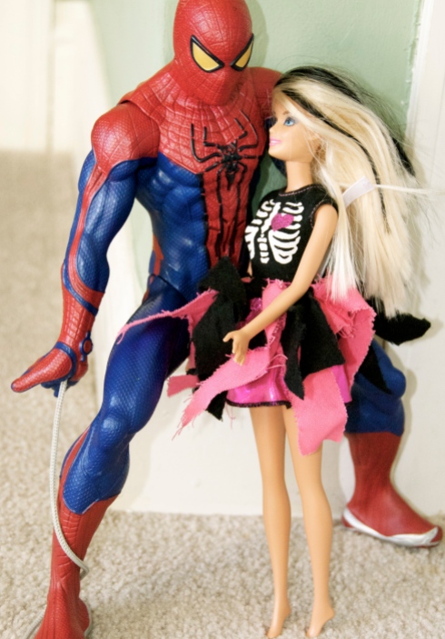 Maddie loves to take Charlie's superhero figures and make them "friends" with her Barbies.