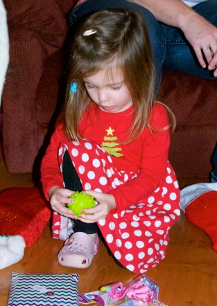 Maddie inspecting the contents of her stocking at Papa's. I love the look on her face here.
