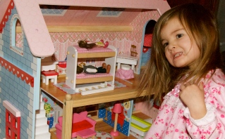 Maddie and her new dollhouse on Christmas morning.
